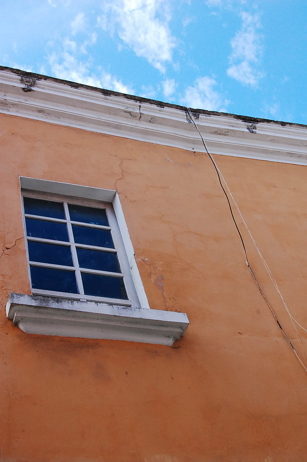 Photograph of wall with  wire by Jennifer Kaplan